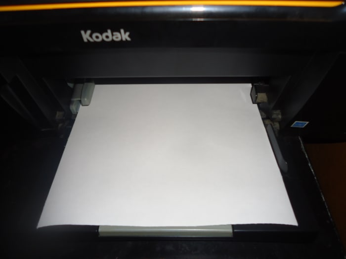 Place fabric sheet in your printer. I place mine in the feeding tray with the fabric side down. Each printer is different so make sure you are placing your fabric sheet properly so it will print on the fabric side.