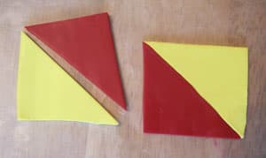 Cut the polymer clay sheets into squares and then triangles for the modified Skinner blend.