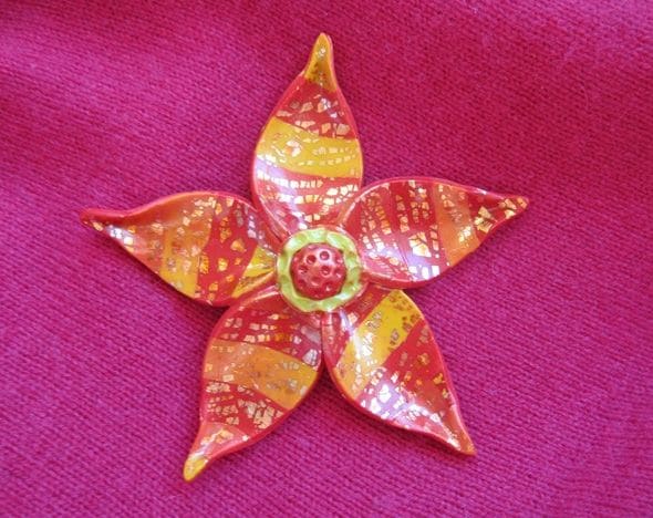 My polymer clay fantasy flower, baked, glazed and ready to attach to a brooch/pin jewelry finding