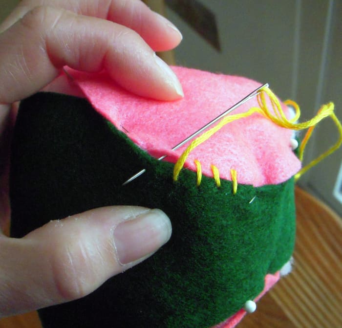 Butt together edges and sew with overhand stitch all the way around. Remove pins as you stitch.
