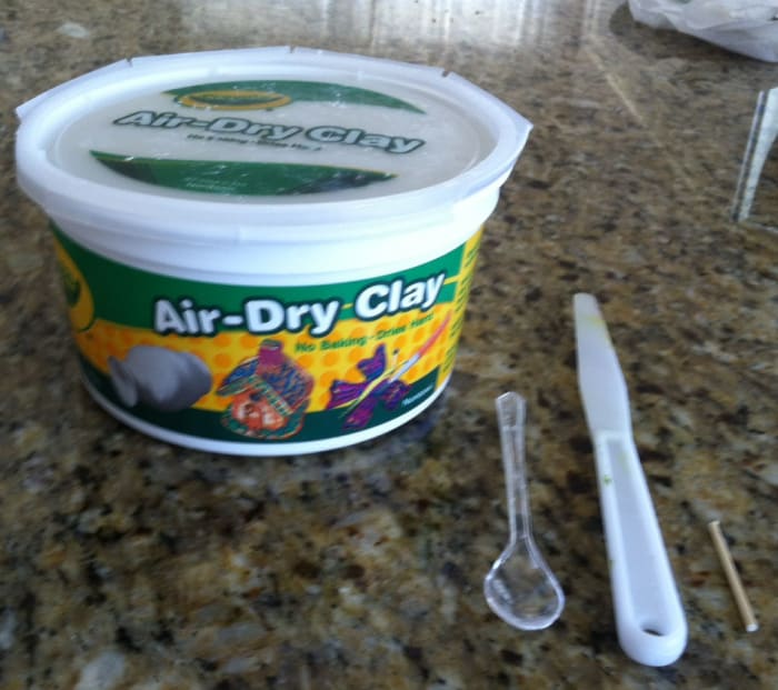 Crayola brand air-dry clay, miniature spoon, plastic palette knife and a miniature dowel. Not pictured but used: toothpicks, wipes, water, paints, brushes.