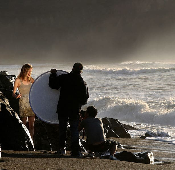 A portable folding reflector positioned to "bounce" sunlight onto a model