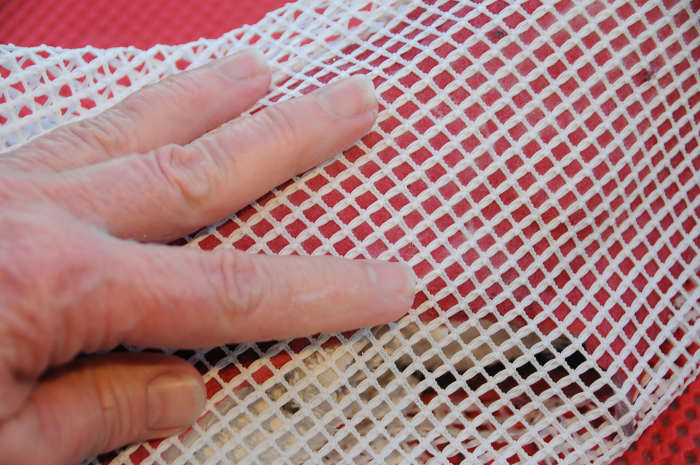 Use a piece of curtain netting to cover the wet fibers and rub gently to flatten down to smooth out the fibers.