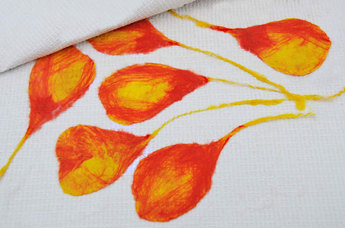 Completed petals arranged between a sheet of thick plastic. In this case, a child's play mat.