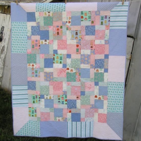 For this quilt, I used a fat quarter bundle to create a boat load of random disappearing nine-patch squares that are framed by mitered borders.