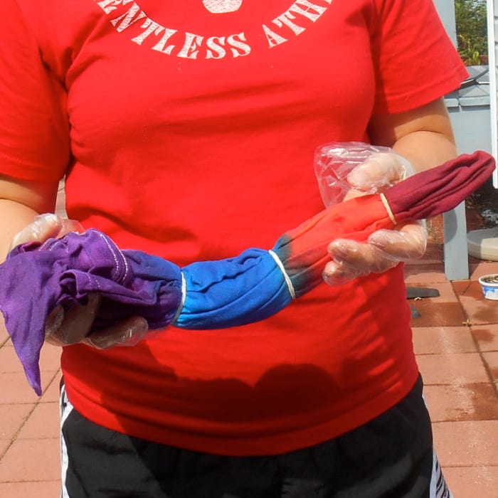 This is one of the t-shirts folded and dyed for a Bull's Eye design. Note the spaced rubber bands separating sections of color.