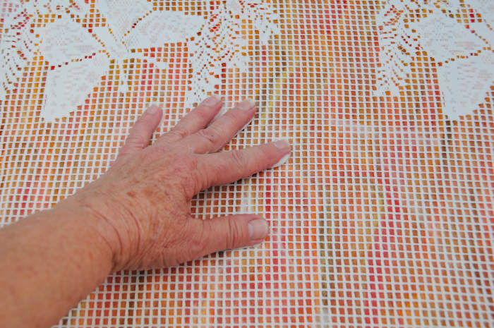 Cover with curtain netting, wet with hot soapy water and smooth out he wool fibers.