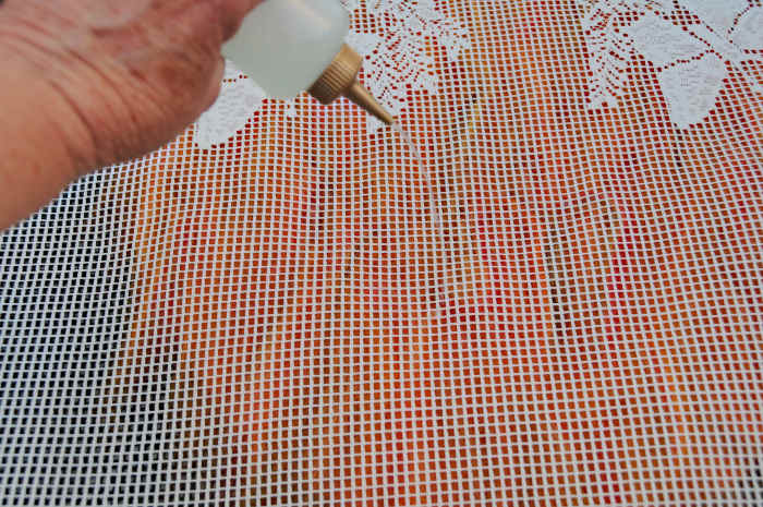 Layer three has been covered with curtain netting, wet with hot soapy water and smoothed and rubbed gently