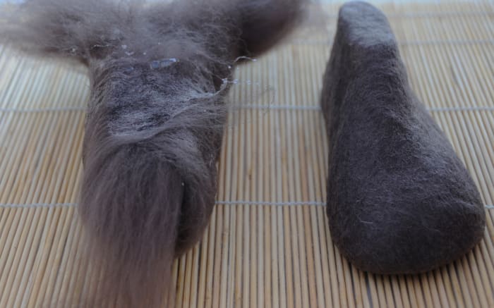 Encase both the shoe lasts in four layers of wool fibers, use the curtain netting to help support the fibers by pulling the netting up tight against the last, Wet with hot soapy water before and after doing so.