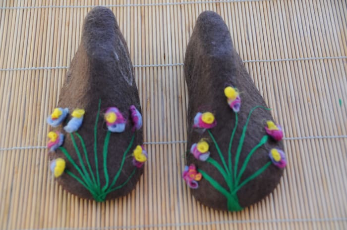 Wet thin pieces of fibers and place them on the surface of the partially felted bootie.