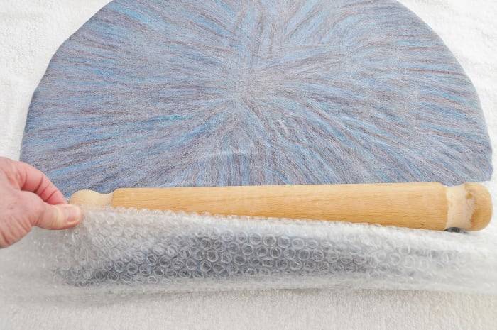 Roll in bubble wrap, bubble side down using a wooden rolling pin or use a bamboo mat
