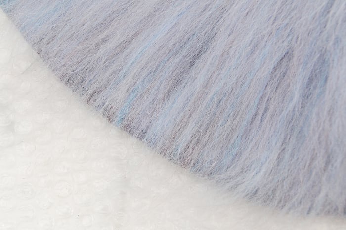 Image shows the final layer of wool fibers being taken to the edge but not over it.