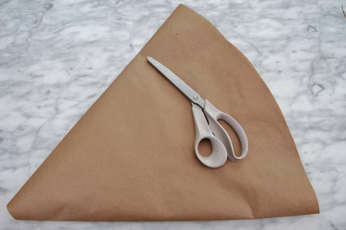 The flattened cone of paper will become the pattern for this project. Fold in one inch from one side