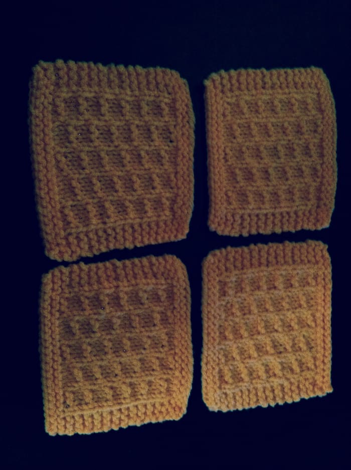 This is an example of a set of four coasters made with this free knitting pattern and ready to be put to use!