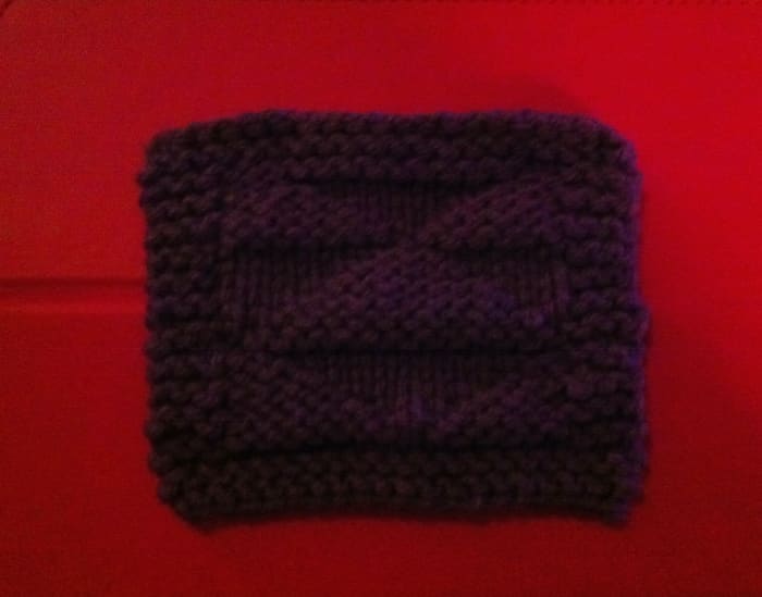 This is an up close example of a single coaster in a coaster set of the pattern of the knitted coaster illustrated in the Triangles part of this article.