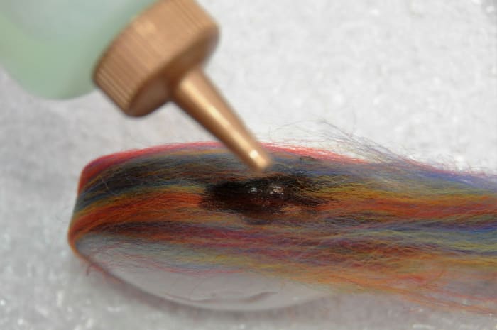 Use the squeeze bottle to add a few drops of water to help ensure that the fibers stick to the soap