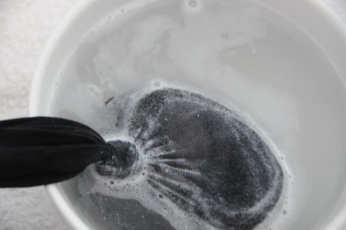 Dip into a bowl of very hot water once the felted soap has been removed from the tumble dryer