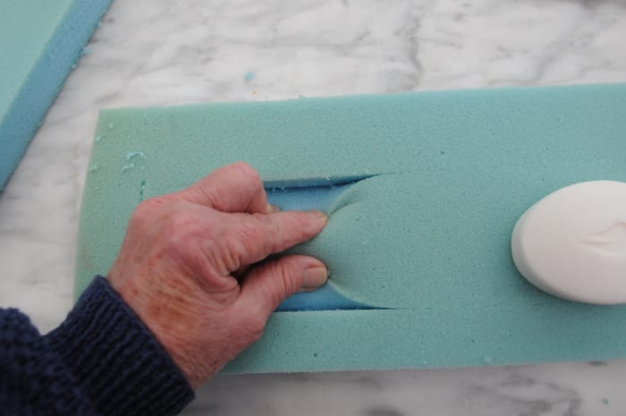 Cut a rectangle into the foam to a dept of about half an inch. Leave a border of about an inch on all sides.