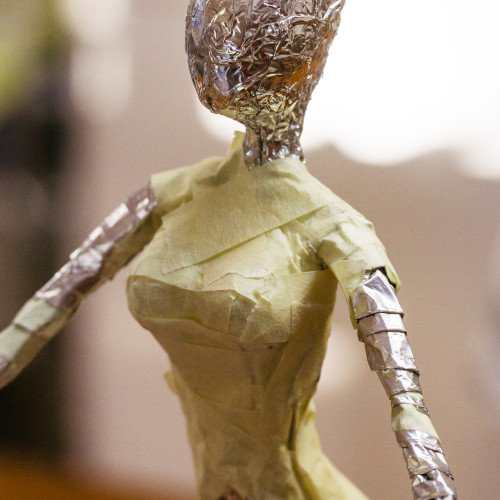 The wire armature after being padded with aluminum foil. After padding, wrap with masking tape to provide added strength.