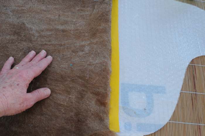 Turn the top edge over, form a straight line across the taped edge of the template.
