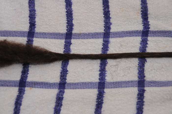 Rub more firmly and the dreadlock will narrow and become firmer under your fingers.