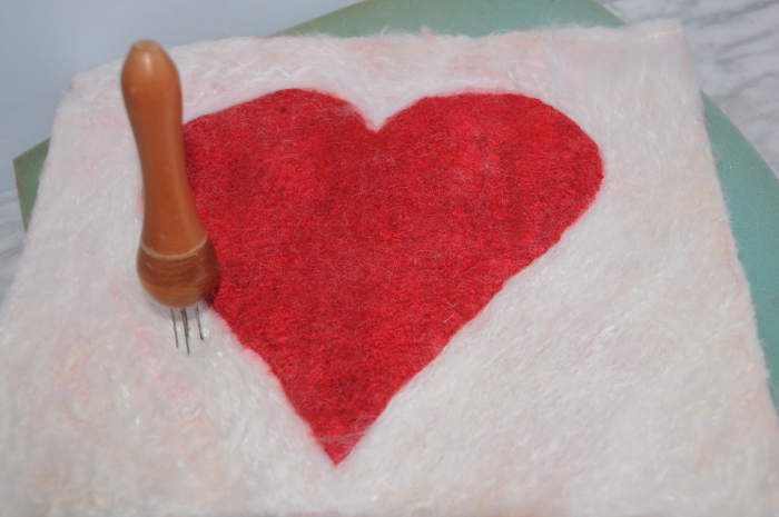 If your red wool bleeds into the white, remember that all is not lost, simply needle felt wool over the stained wool.
