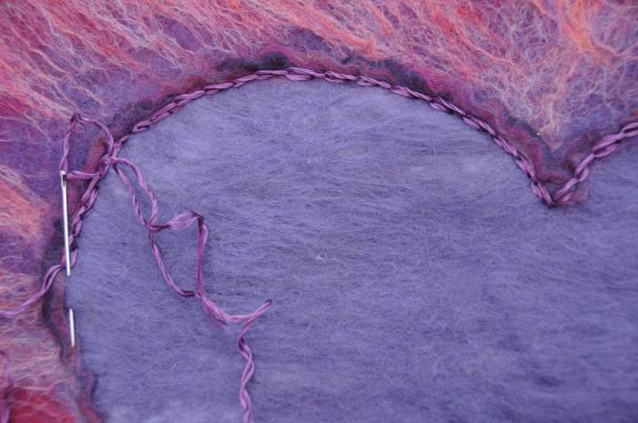 Embroider chain stitches around the inside of the heart with a few strands of embroidery thread.