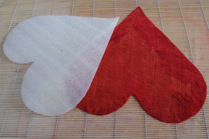 A template covered in red wool. Be careful not to use red on white if the wool is not color fast.
