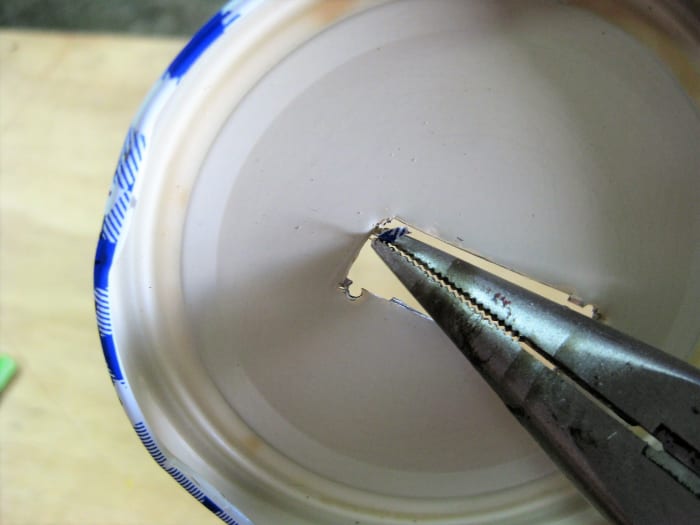 You can remove stubborn pieces with a pair of needle nose pliers by wiggling back and forth until it breaks free.