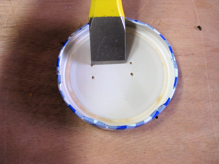 Line up 1" straight edge punch to the outside of one corner. Punch out a line that connects to the opposite corner.