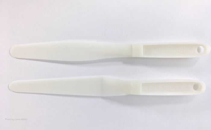 These two plastic palette knives from a Grumbacher palette and painting knife set are about 10" long and made from a durable plastic that's easy to clean.