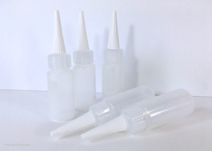 Plastic squeeze bottles can be filled with your paint and medium mixture and used to create additional designs in your piece.