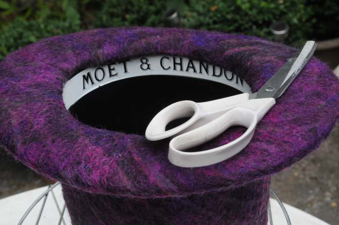 Cut off any excess felt from the bottom of the hat, keep it aligned to the inner edge.