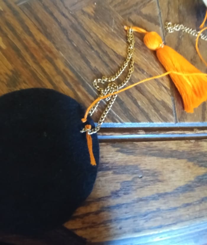 Sew the other end of chain on the felt circle. Right behind and next to the other end of sewn chain.