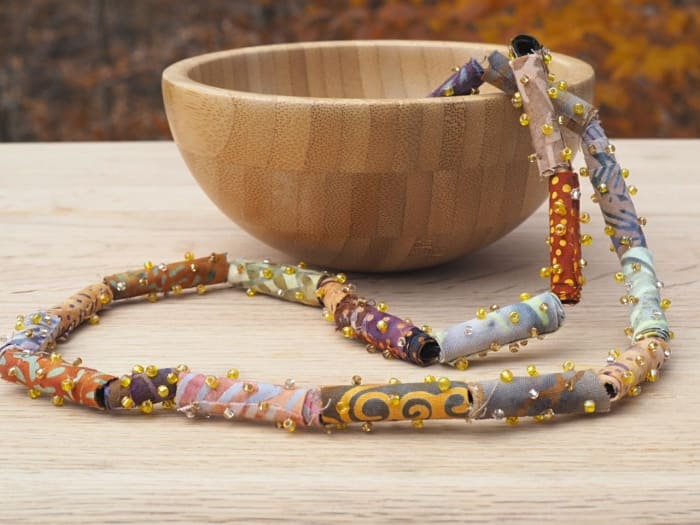 Learn how to make batik fabric beads and turn them into a earthy tribal piece of jewelry with this tutorial.