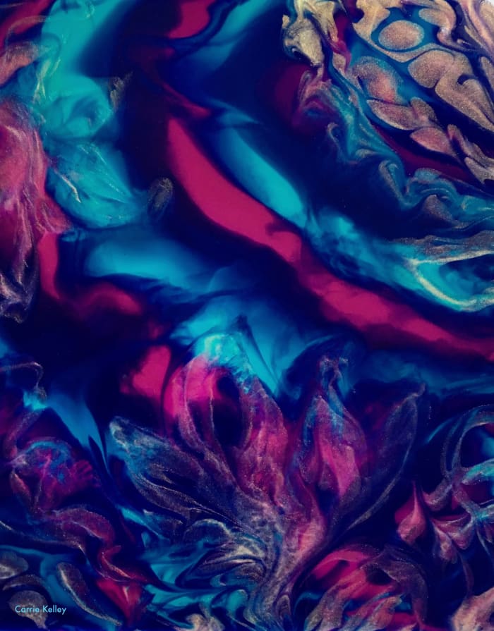Paintings created with the acrylic ink pouring technique often have a stained glass appearance on smooth surfaces. This is one I did on a wood panel.