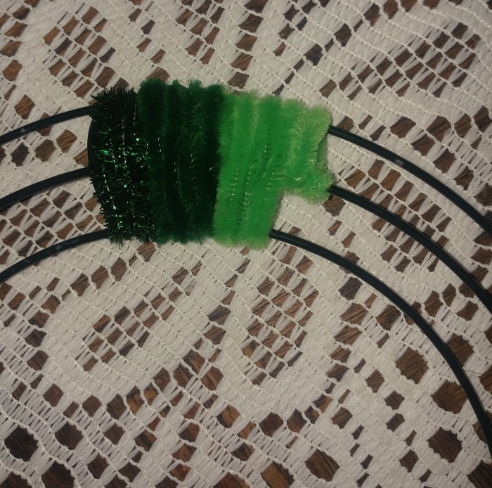 A pattern of green fuzzy sticks is nice for this craft. Any green or gold pattern is ideal for this wreath.