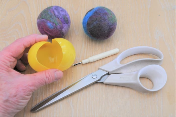 To make small balls, use plastic water play balls which should be cut open as shown. Leave a quarter of the ball intact.