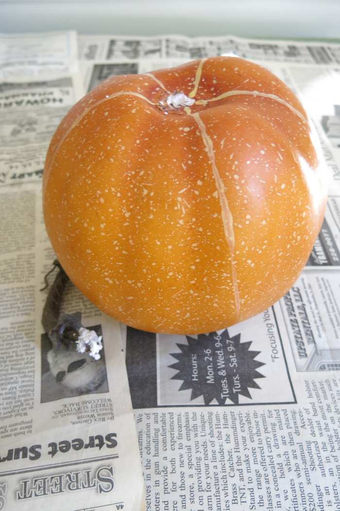 Remove the stems from your pumpkins to begin making a stacked pumpkin decoration.