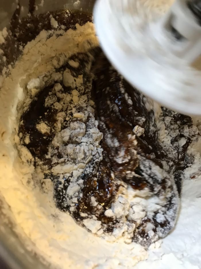 I use a dough hook on the mixer, and add the flour in about three batches to make it easier to scrape down the sides of the bowl. This is a heavy dough, so patience pays off.