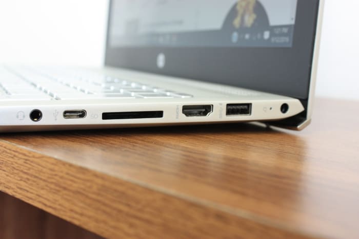 Equipped with 3 standard USB ports and a USB-C port; HDMI port, SD card slot, laptop lock slot, and headphone jack.