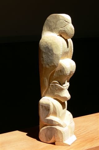 Part of Rupert's pole part way through the course. Note how the cuts are symmetrical before the rounding. Also not the lines marking the place where the eyes will be carved out.