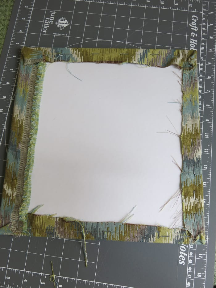 staple your fabric on all sides, making sure that it looks smooth and tight from the front of your bulletin board