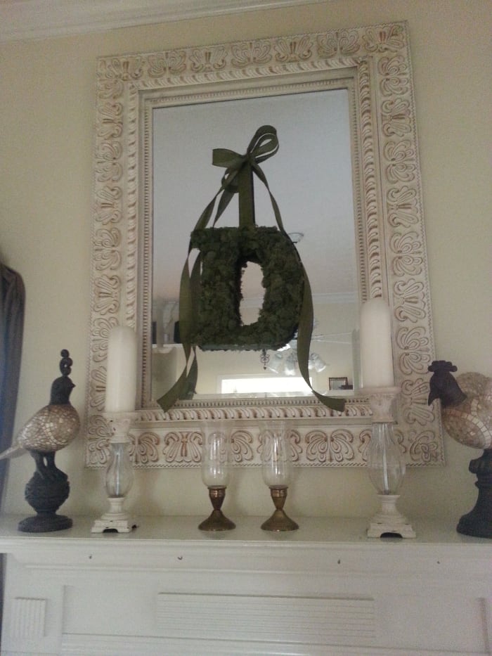 Moss covered monogram / wreath hanging on a mirror above my fireplace.