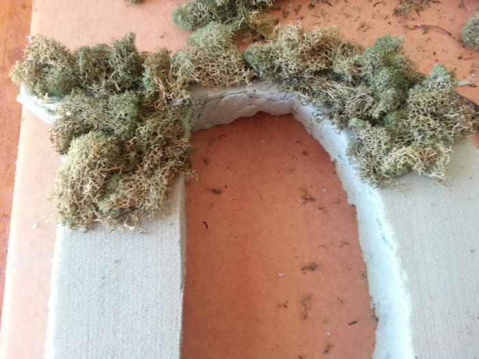 Slowly covering the Styrofoam letter with moss. It looks pretty rough in the beginning, but do not lose heart, for it will shape up nicely.