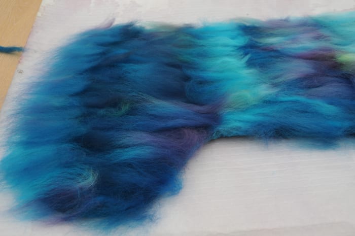 Add the final layer using usual method of putting down fibers as shown here. This is the decorative layer.