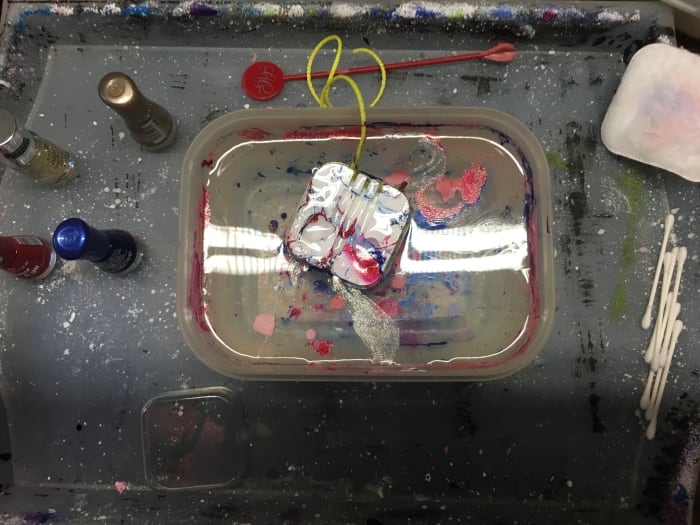 After the headphone case has been dipped into the nail polish, remove the excess with a tooth pick, and hang it up to dry. It's not long before it is done!