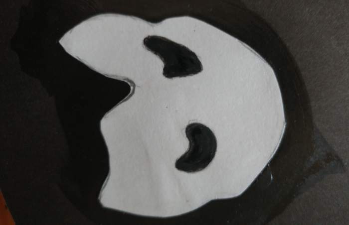 I found it easier to paint eyes black instead of cutting the eye holes out. Be sure to go over with mod podge and let it dry FIRST, before painting the eyes.