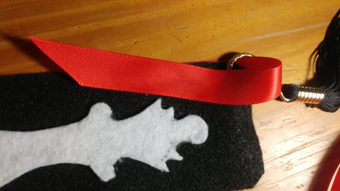 Glue the remaining ribbon over the front of bookmark. Don't forget to slip tassel in before you glue.