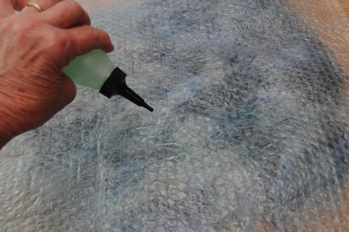 Wetting the surface of the bubble wrap using warm soapy water which will help facilitate easy rubbing of the fingers on the surface.